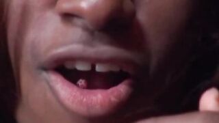 La transexual tetona negra muestra su lengua rosa