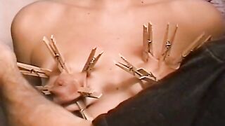 Horny dude loves putting clothes pegs on his slaves tits